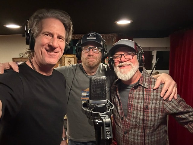 Three band members in recording studio